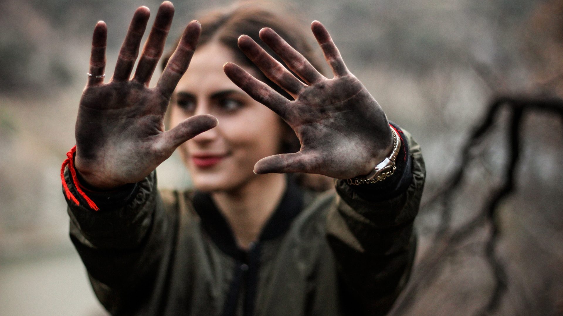 Woman holding her dirty hands out at camera