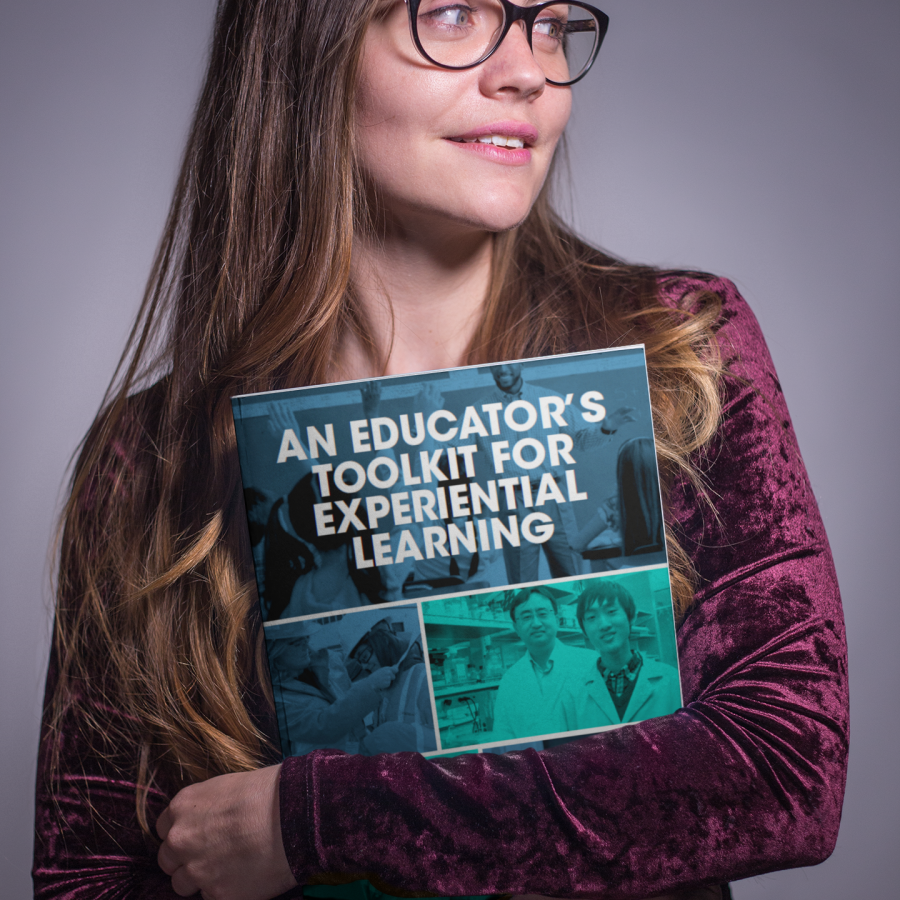 Woman holding An Educator's Toolkit for Experiential Learning