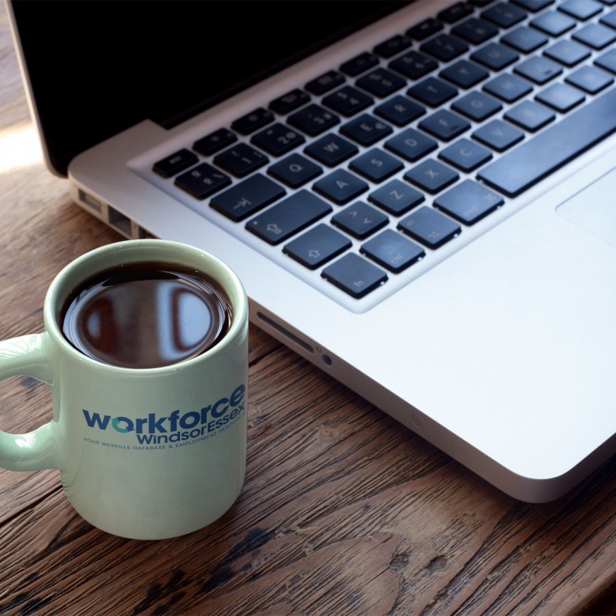 Workforce WindsorEssex mug next to laptop computer