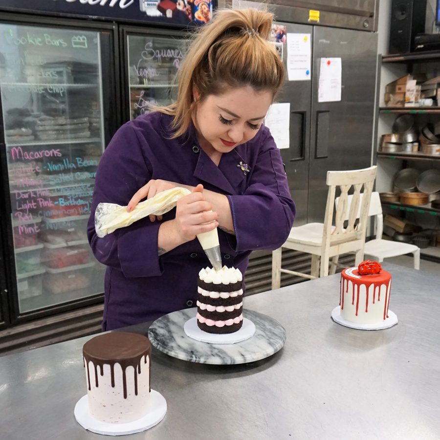 Sweet Revenge Bake Shop baker decorating cakes