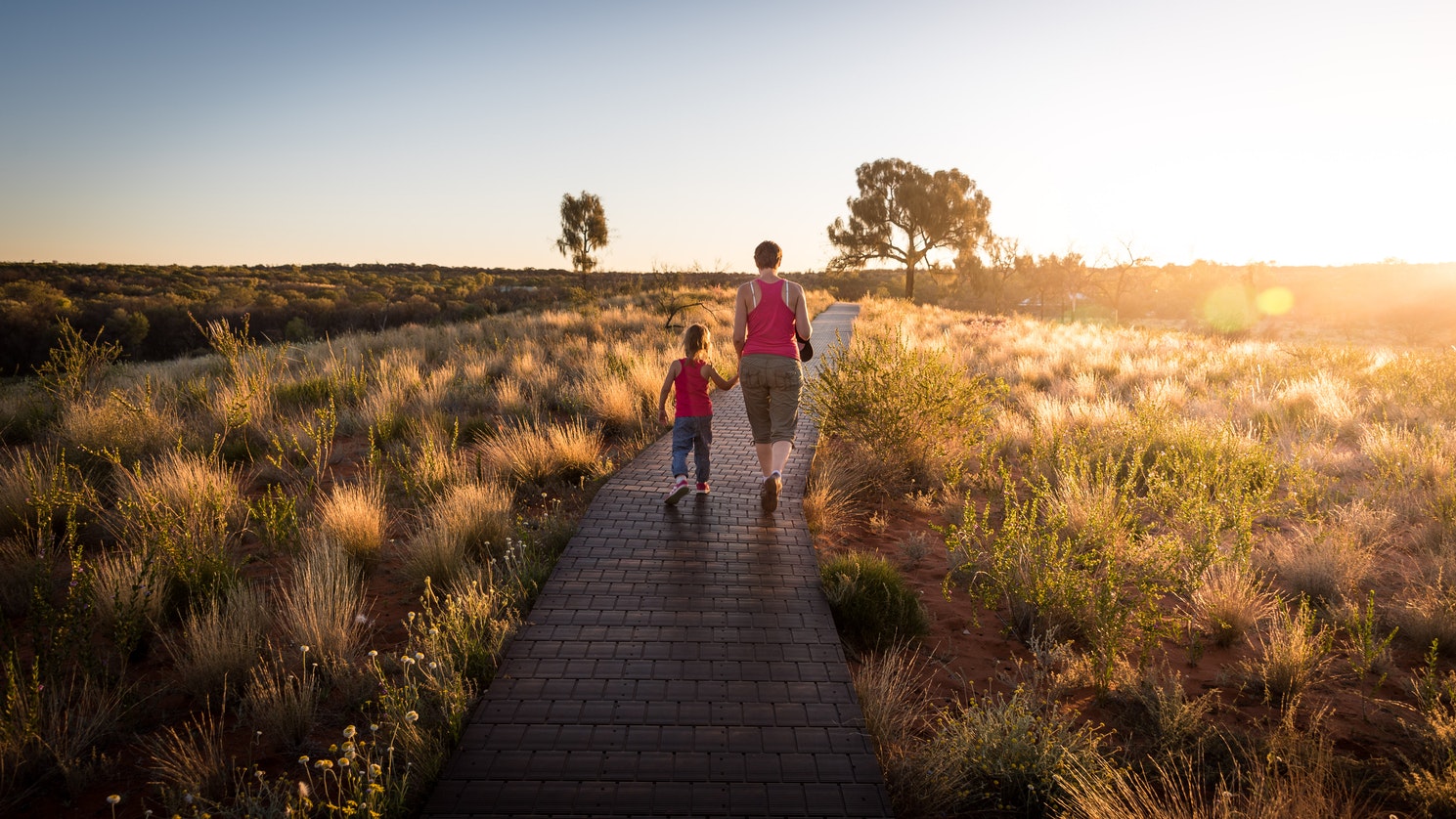 Woman and child walking along path outdoors