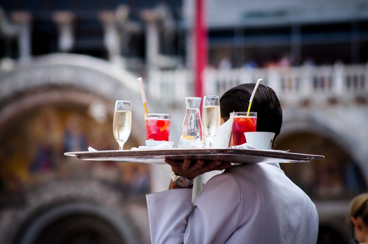 Man holding tray of drinks