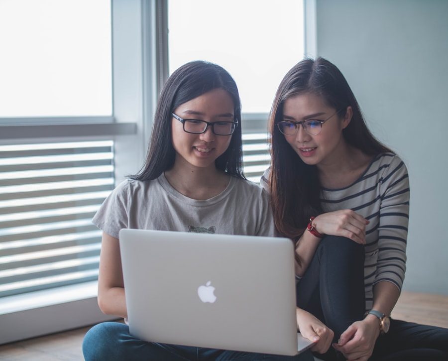 Two young women looking at a laptop computer